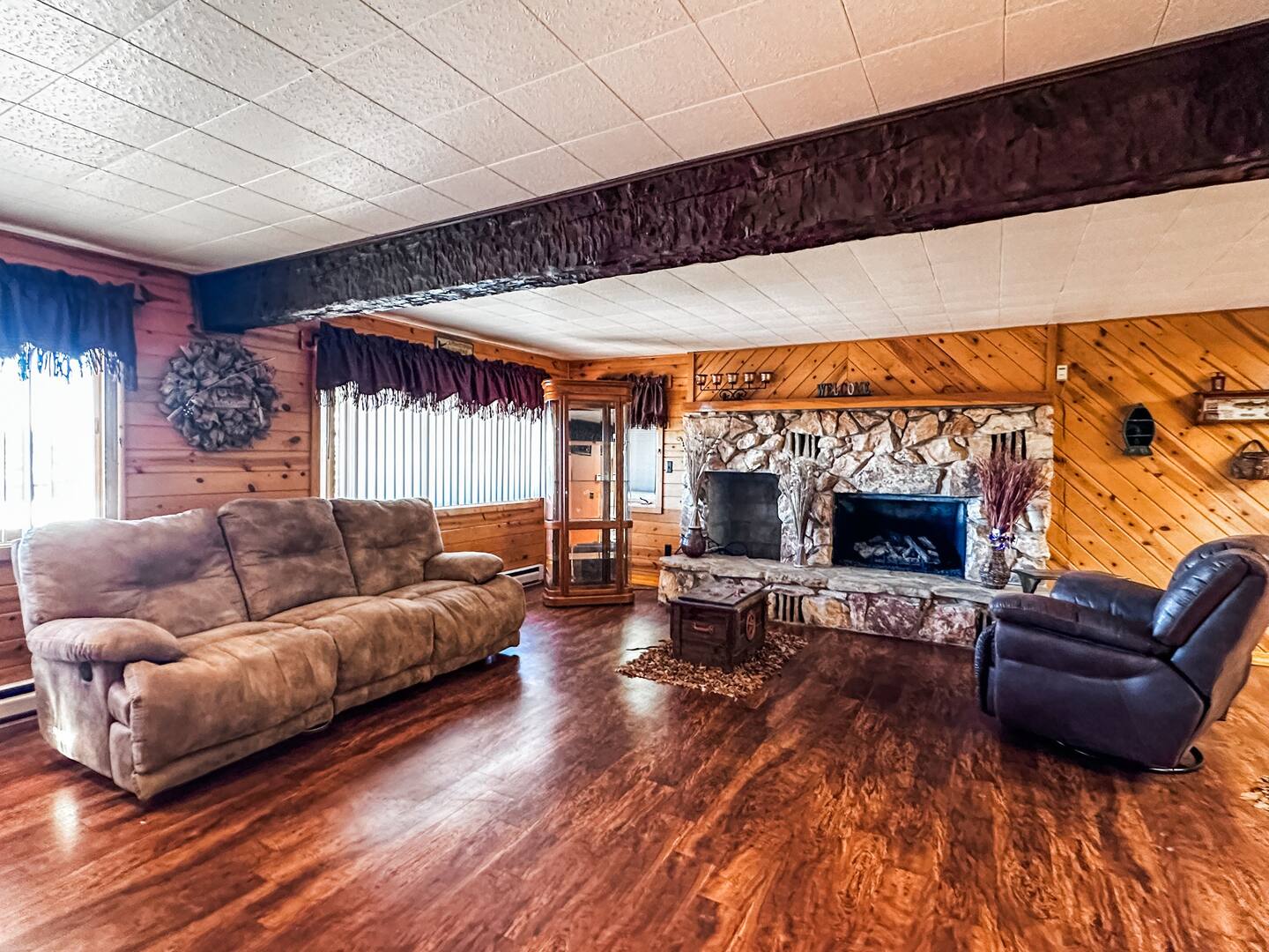 basement living area with wood paneling and flooring