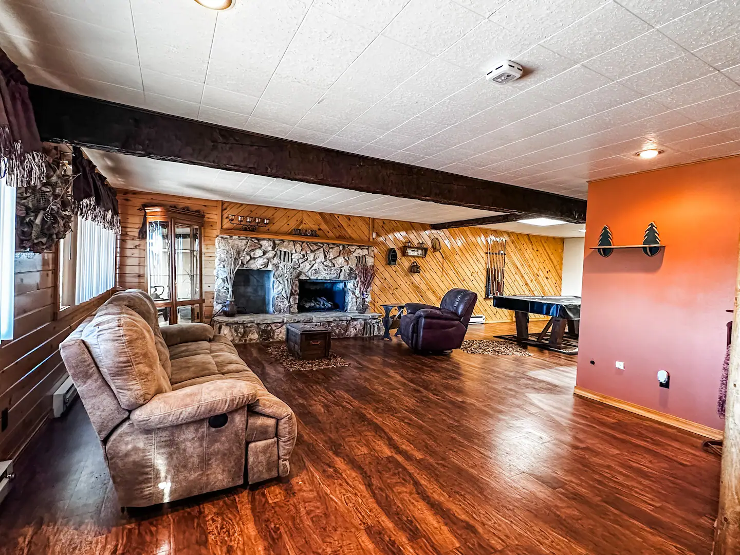 basement with wood flooring and fireplace
